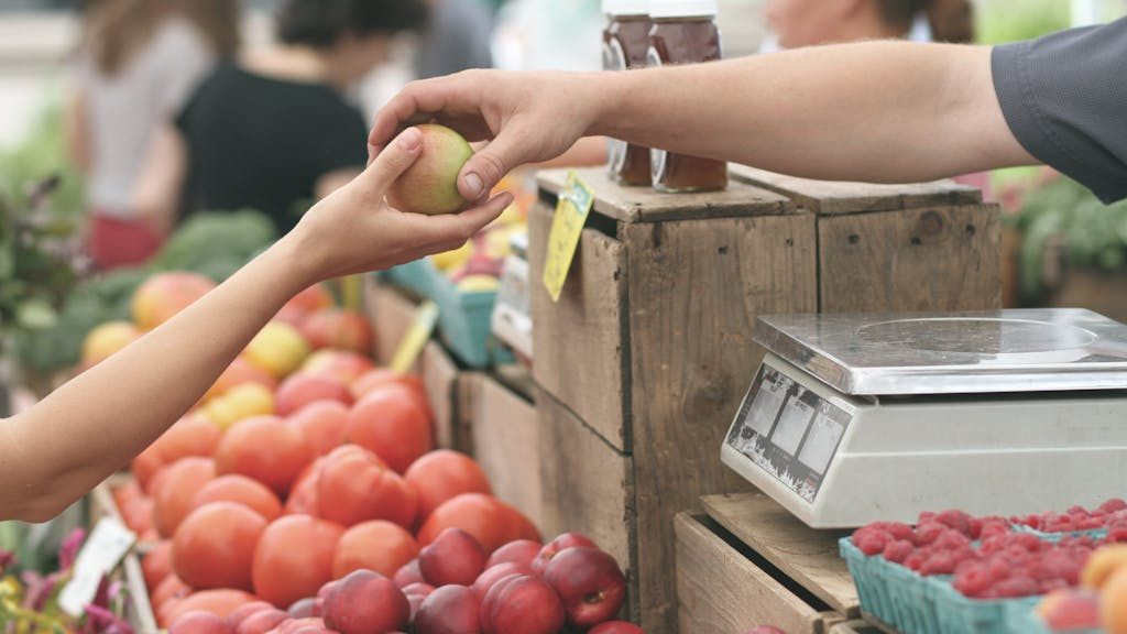 Person Giving Fruit to Another